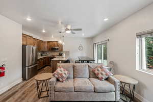 Living area with dark wood finished floors, a ceiling fan, and recessed lighting
