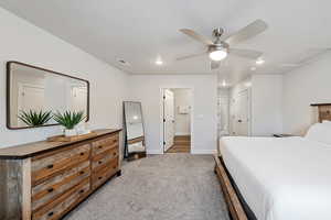 Bedroom featuring ceiling fan, light carpet, recessed lighting, a closet, and attic access