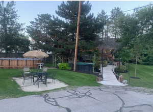 View of yard with a pool and a patio