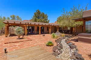 Rear view of house with a patio area and stucco siding