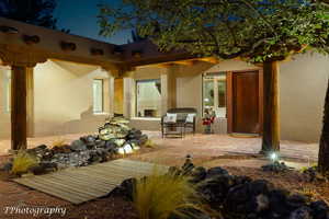 Back of house with a patio area and stucco siding