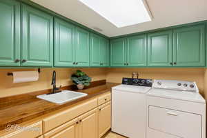 Washroom featuring washer and dryer and cabinet space