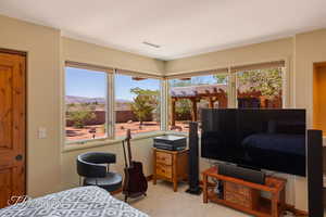 Bedroom with light carpet and baseboards