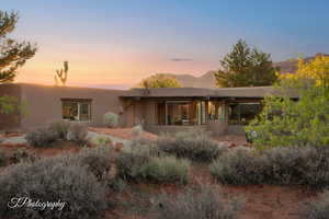Back of house with a patio, stucco siding, and a mountain view