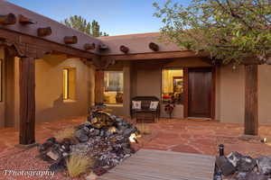 View of exterior entry with a patio area