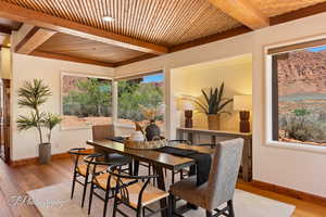 Dining area featuring hardwood / wood-style floors, a wood ceiling with exposed beams, and recessed lighting