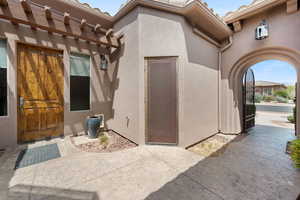 Doorway to property with stucco siding
