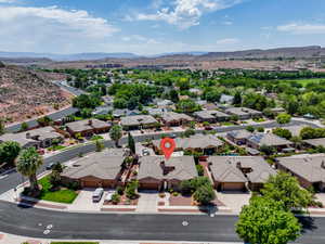 Aerial perspective of suburban area featuring a mountain backdrop