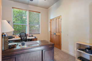 Office featuring light colored carpet and ceiling fan