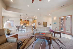 Living area with light tile patterned floors, recessed lighting, a ceiling fan, and french doors