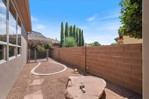 View of yard featuring a patio area and a gate