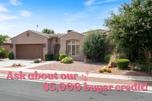 View of front of house featuring a tiled roof, an attached garage, driveway, and stucco siding