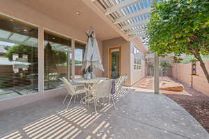 View of patio featuring a pergola and outdoor dining area