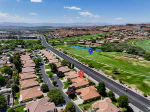 Aerial perspective of suburban area featuring a water and mountain view and a golf course