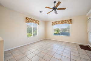 Spare room featuring light tile patterned floors and a ceiling fan