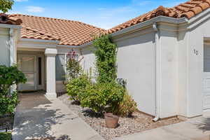 View of home's exterior featuring stucco siding, a tiled roof, and a garage