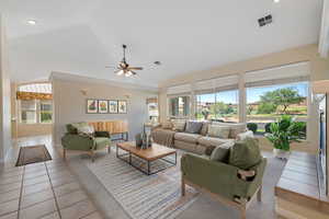 Living room featuring a ceiling fan, light tile patterned floors, recessed lighting, and high vaulted ceiling