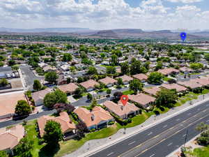 Aerial perspective of suburban area featuring a mountainous background