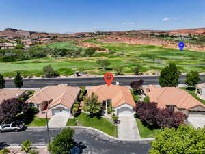 Aerial perspective of suburban area with a golf club and a mountain backdrop