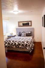 Bedroom featuring a textured ceiling and baseboards