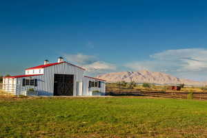View of pole building featuring a mountain view and a view of rural / pastoral area