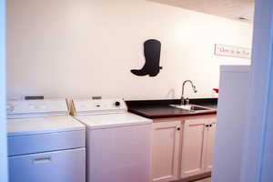 Laundry area featuring washer and dryer and cabinet space