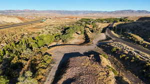 Aerial view of property and surrounding area featuring mountains