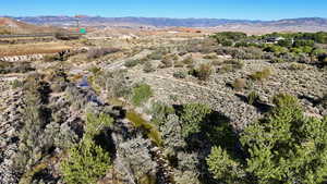 Aerial overview of property's location featuring a mountainous background