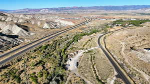 Aerial view of property and surrounding area with a mountainous background
