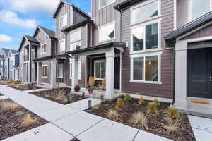 View of front facade with a residential view, board and batten siding, and a porch