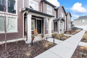Entrance to property with a porch, board and batten siding, and a residential view