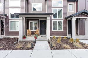 Property entrance with board and batten siding and covered porch