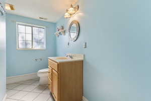 3/4 bathroom featuring light tile patterned floors and vanity