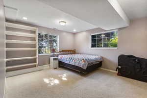 Carpeted bedroom with a textured ceiling and recessed lighting