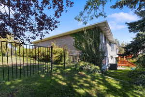 View of side of home featuring a cooling unit and brick siding