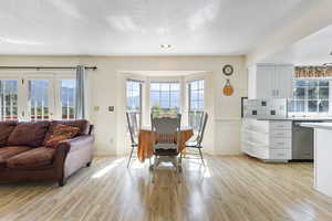 Dining room featuring a textured ceiling, light wood-style flooring, and recessed lighting