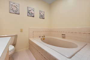 Full bathroom with light tile patterned floors, a bath, and vanity