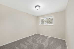 Unfurnished room with carpet flooring and baseboards