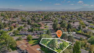 Aerial perspective of suburban area featuring mountains and property boundaries highlighted