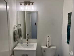 Half bath featuring vanity and toilet