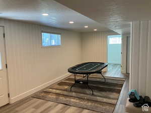 Playroom featuring a textured ceiling, light wood finished floors, and recessed lighting