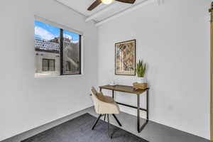 Second bedroom featuring finished concrete floors and a ceiling fan