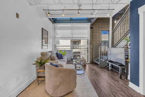 Living area featuring wood finished floors and stairway