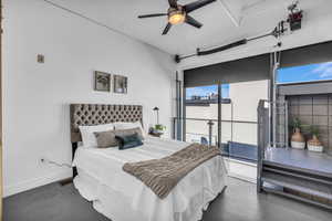 Bedroom featuring concrete flooring, access to exterior, and ceiling fan