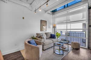 Living area with wood finished floors and baseboards