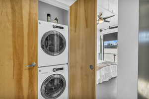 Washroom with ceiling fan and stacked washer / drying machine