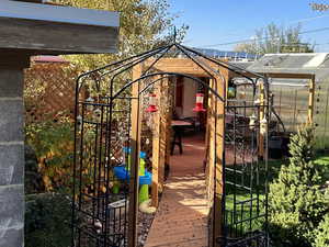 Wooden deck featuring an outdoor structure and a greenhouse