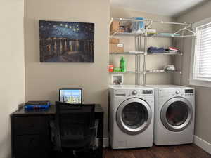 Laundry area featuring dark wood-style flooring, a textured ceiling, a desk, and washer and clothes dryer