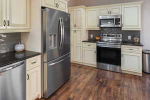 Stainless steel appliances, granite countertops, tile backsplash