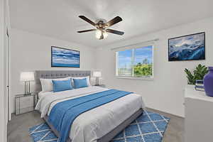 Carpeted bedroom with a ceiling fan and baseboards